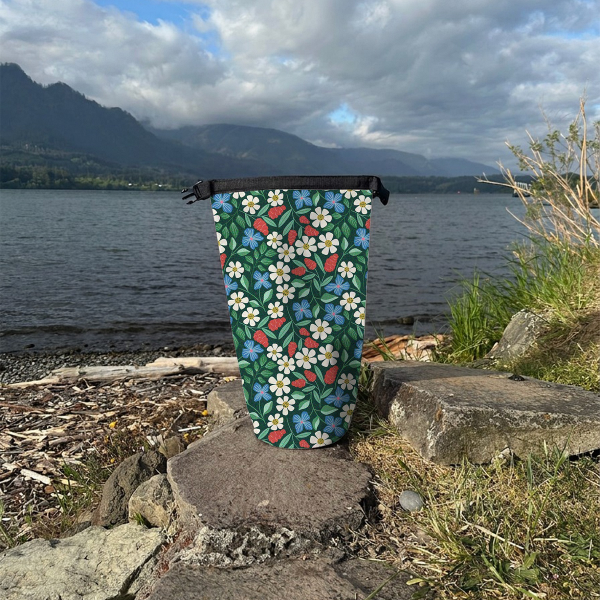 Spaulding Dry Bag open on a rock with a river background