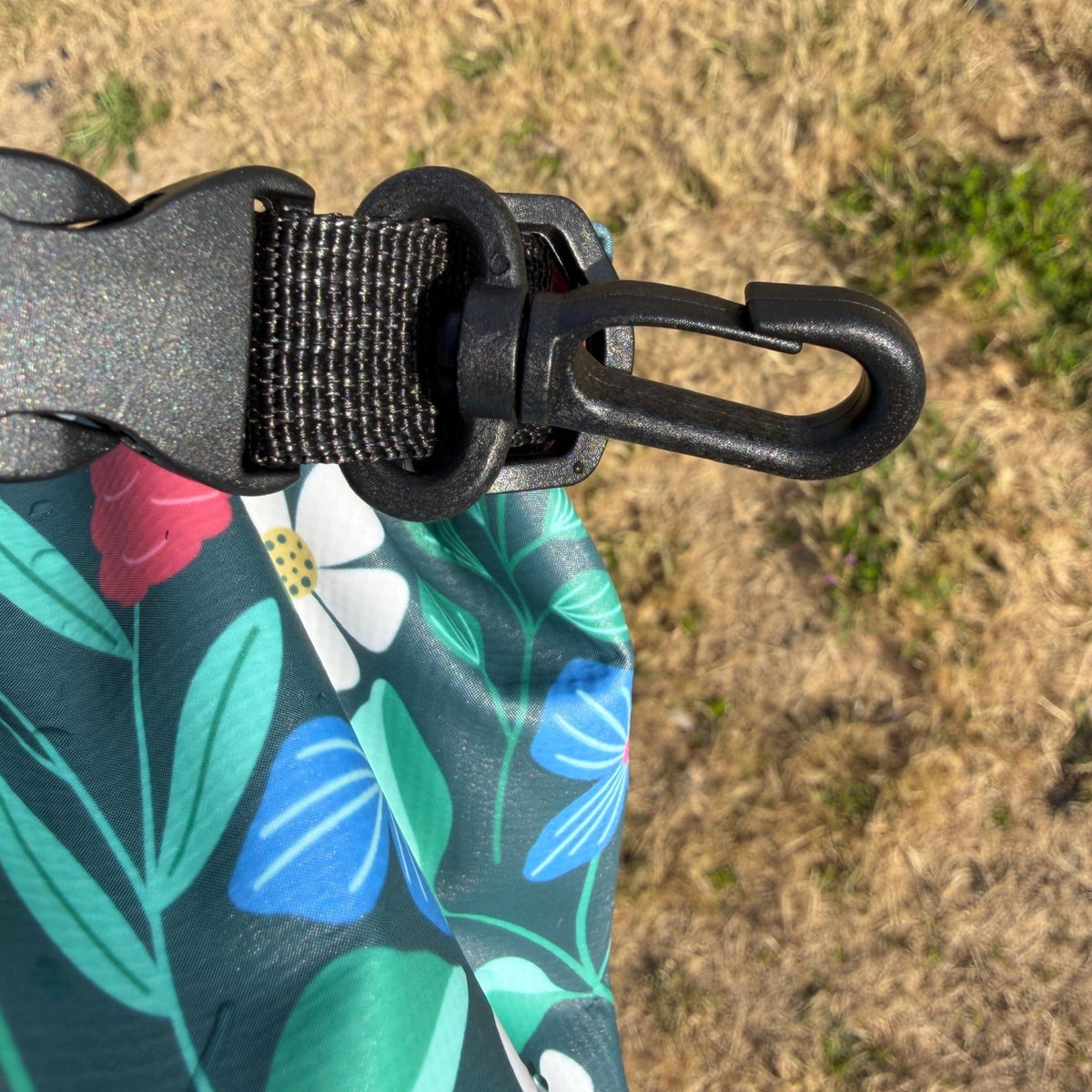 Dry Bag Clip on a floral dry bag above dry grass