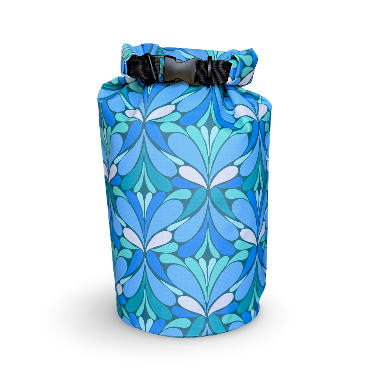 Yuba 20L waterproof wet-dry bag featuring a blue and teal retro geometric floral pattern, packed and buckled shut against a clean white background.