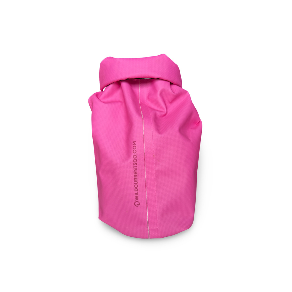 Side view of the hot pink waterproof dry sack showing its durable welded seam construction against a white background.